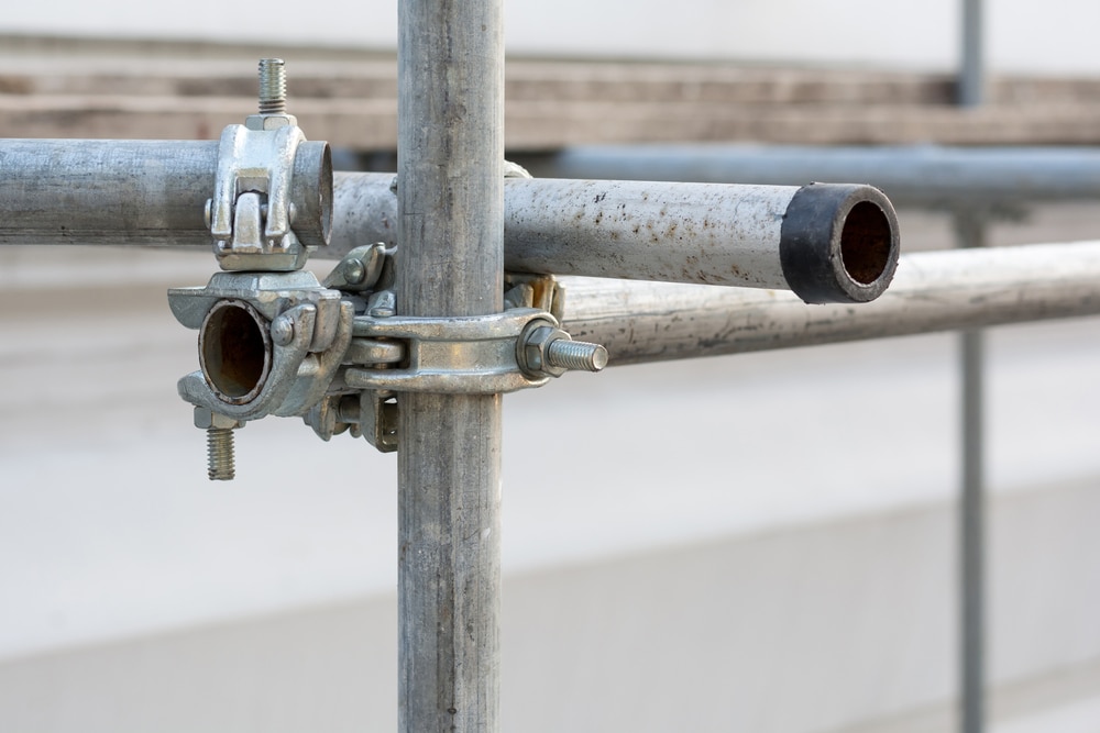 How should erected scaffolding be inspected daily
